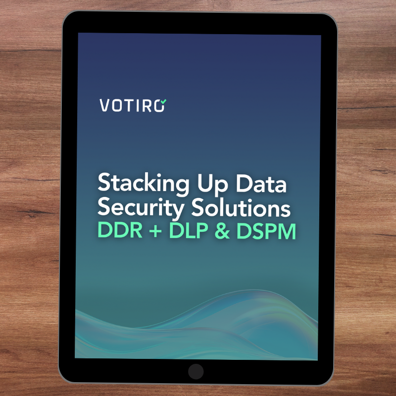 A tablet sits on a desk with the solution brief, "Stacking Up Data Security Solutions: DDR + DLP & DSPM" on top of it.