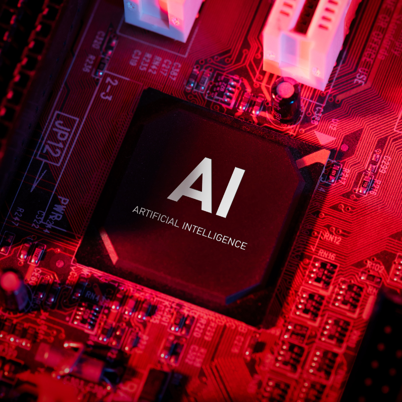 A computer board has a chip titled AI Artificial Intelligence.