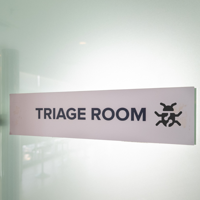 A hospital sign reads "Triage Room" next to the symbol for a malware bug.