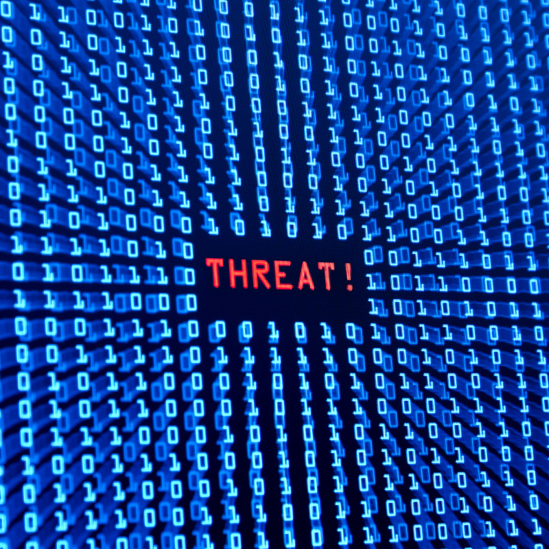 A screen filled with the numbers 1 and 0. In the middle is a big red THREAT!