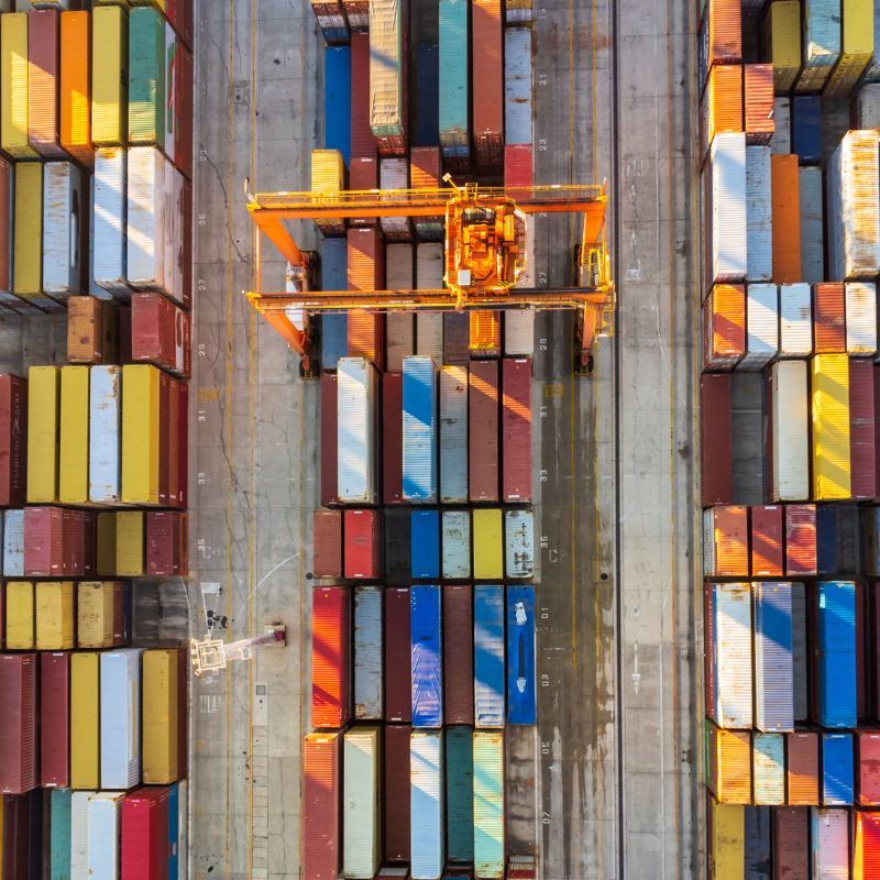 An overhead view of a shipping yard with a bunch of colorful shipping containers.
