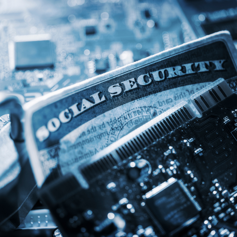 A Social Security card is surrounded by computer chips and a padlock.