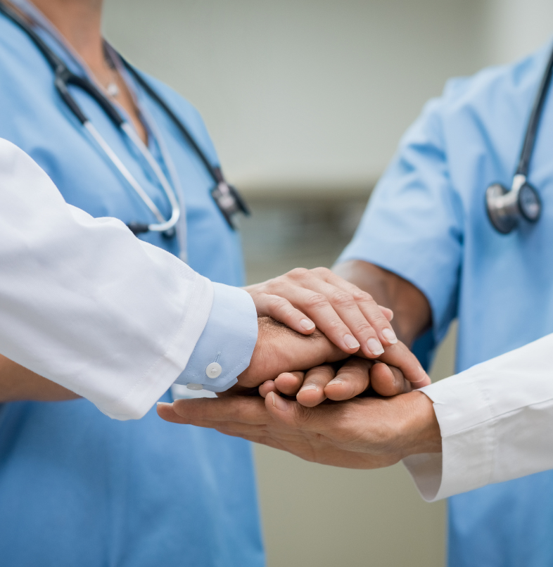 Doctors and nurses holding hands in a circle