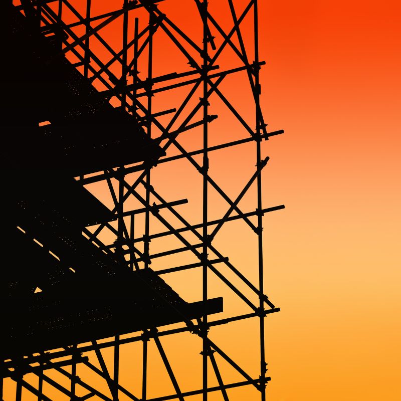Scaffolding against a red and orange sky
