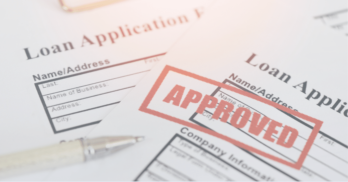 Stack of loan applications stamped with approval