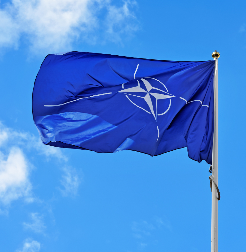 NATO flag against a blue sky
