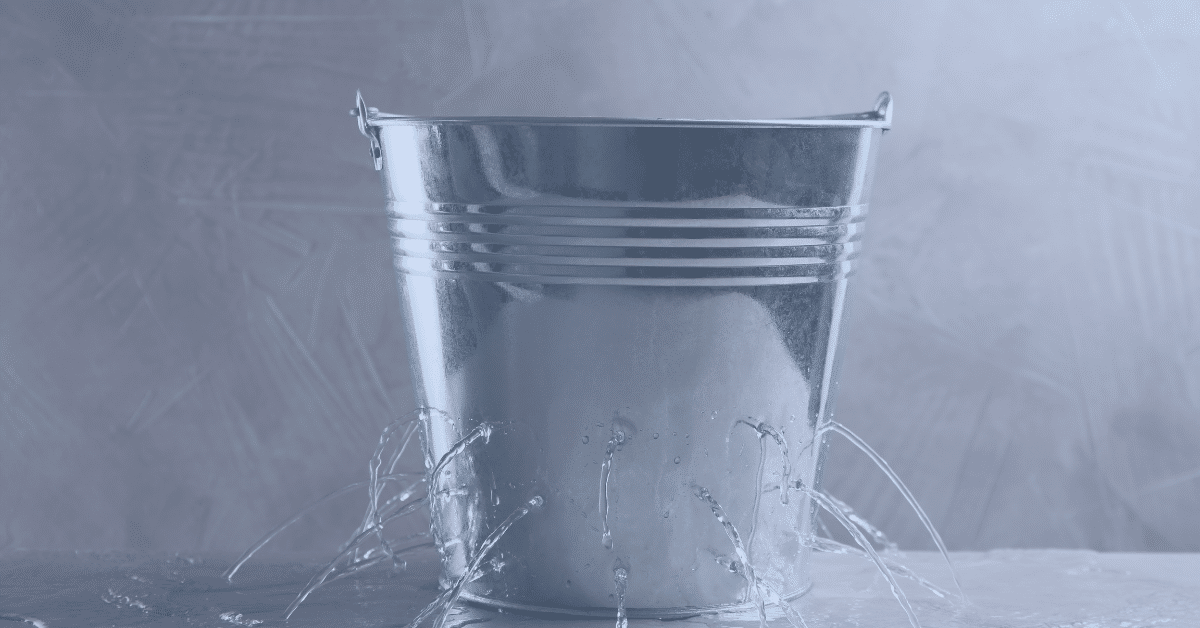 Bucket with water leaking out of holes - Votiro