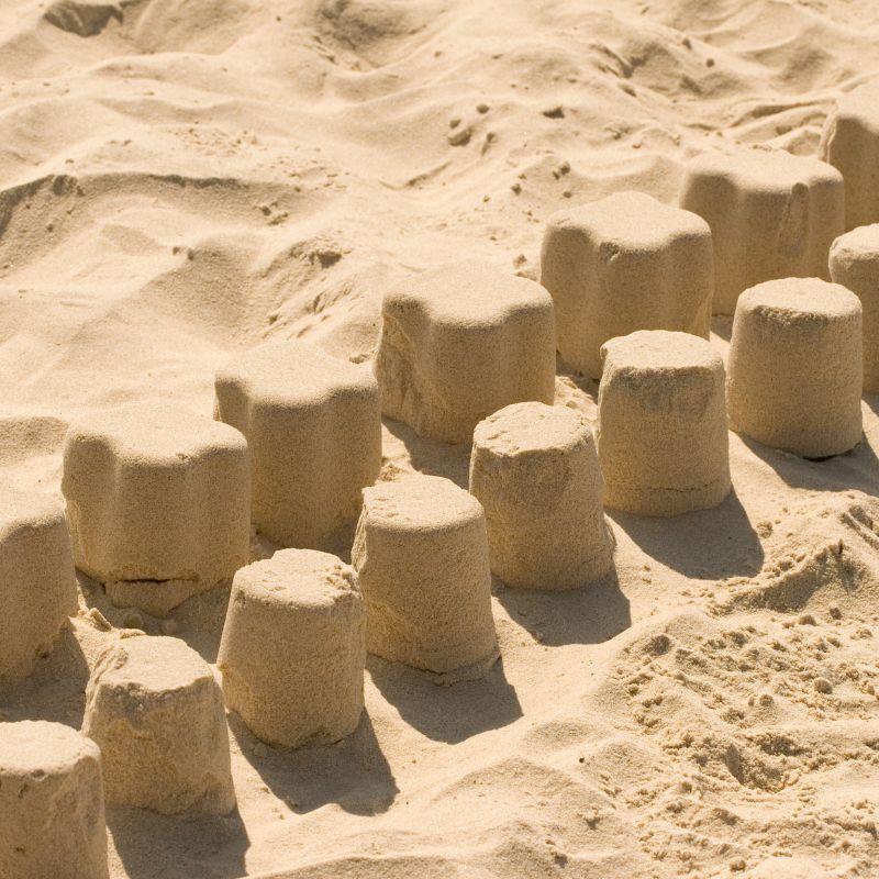 Small sandcastle wall on the beach