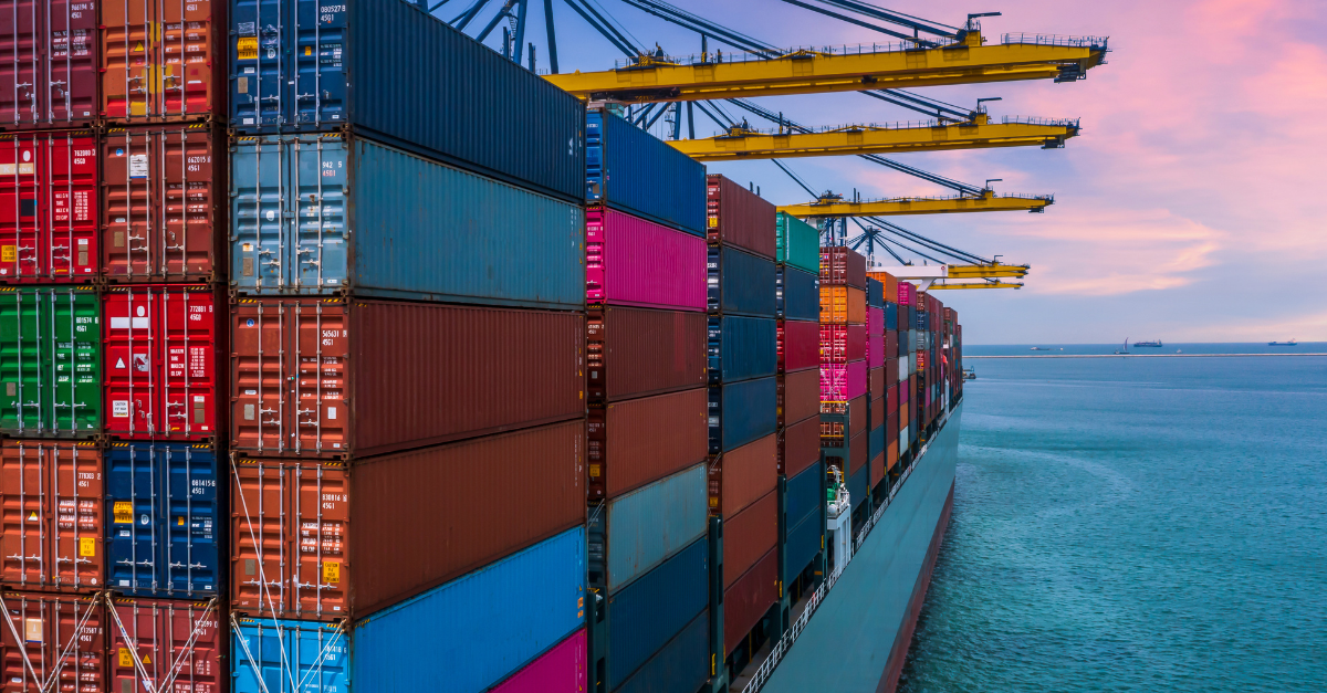 Multi-colored large shipping containers stacked on a freighter in the ocean for the shipping and logistics customer story