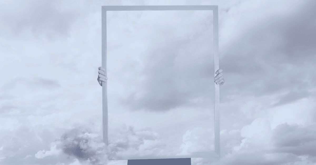 Person holding invisible frame with clouds in background - Votiro